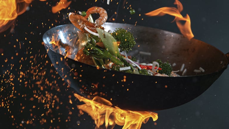 Wok cooking with fire flames