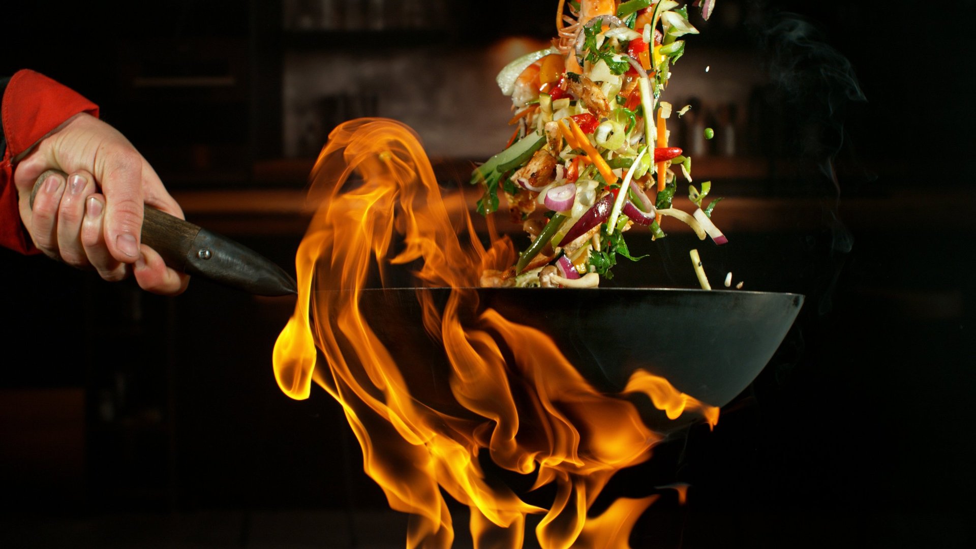 Wok cooking with fire flames