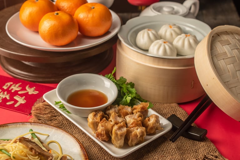 Assorted Chinese dim sum in bamboo steamer with festive decorations