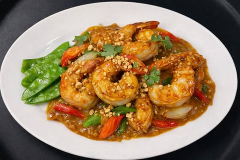 Stir-fried shrimp with snap peas, red peppers, and sesame seeds on a white plate