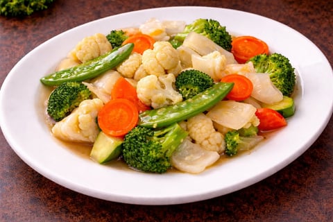 Stir-fried shrimp and vegetables dish with broccoli, carrots, and green beans on a white plate